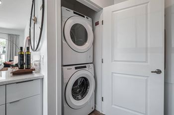 a white washer and dryer in a laundry room at Altis Grand Suncoast, Land O' Lakes Florida
